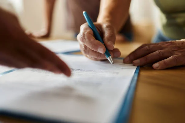 hand signing paper